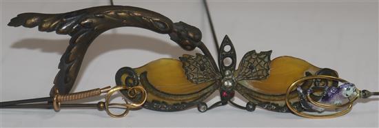 Five assorted hatpins including enamel, horn and French 18ct gold.
